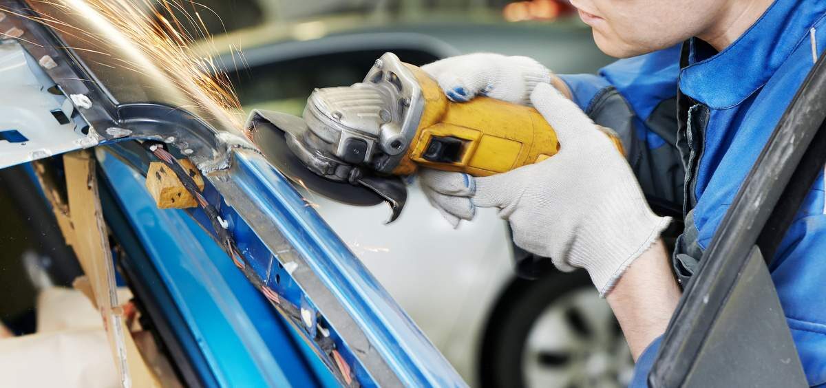repairman-grinding-metal-body-car